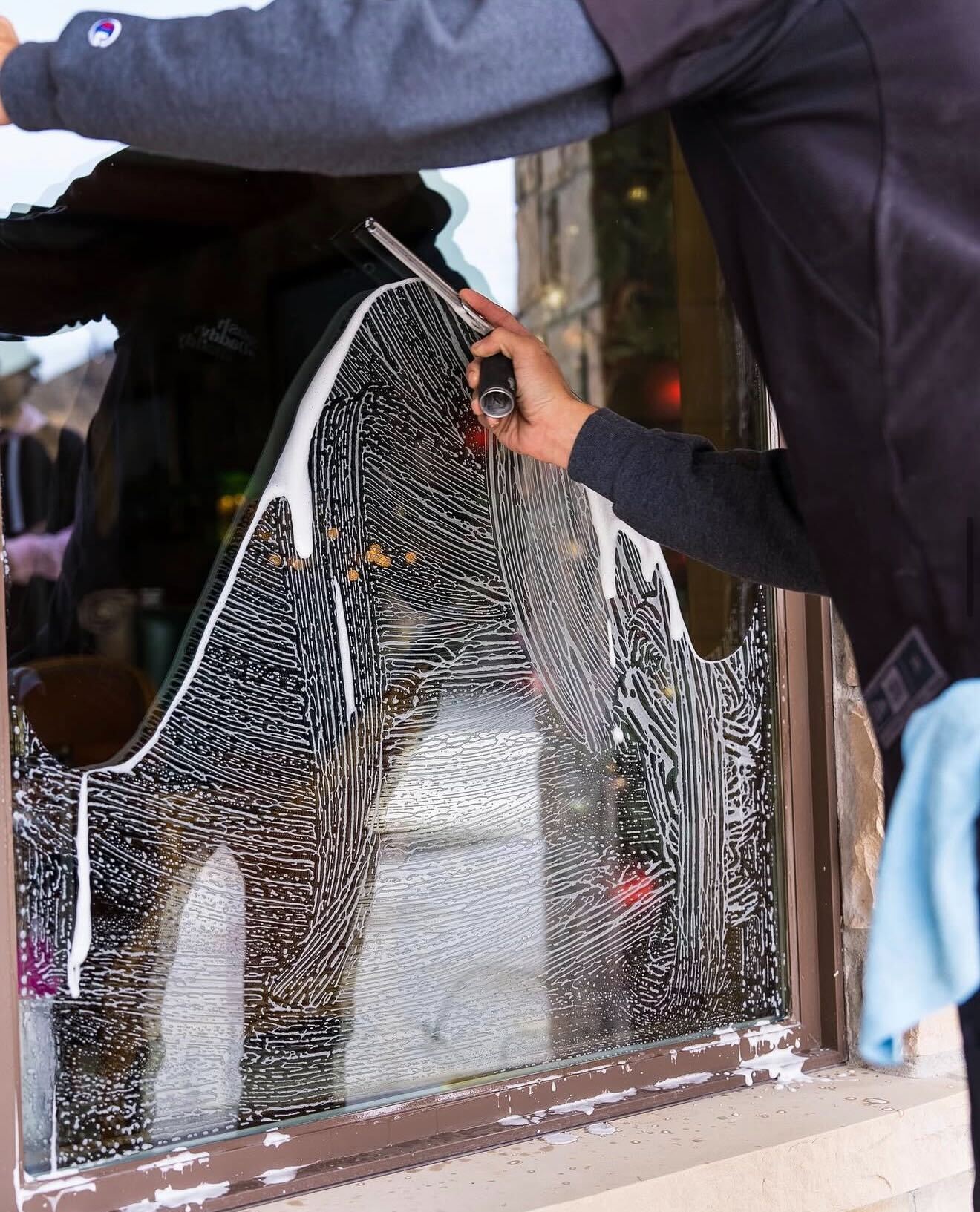 A provider cleaning a window